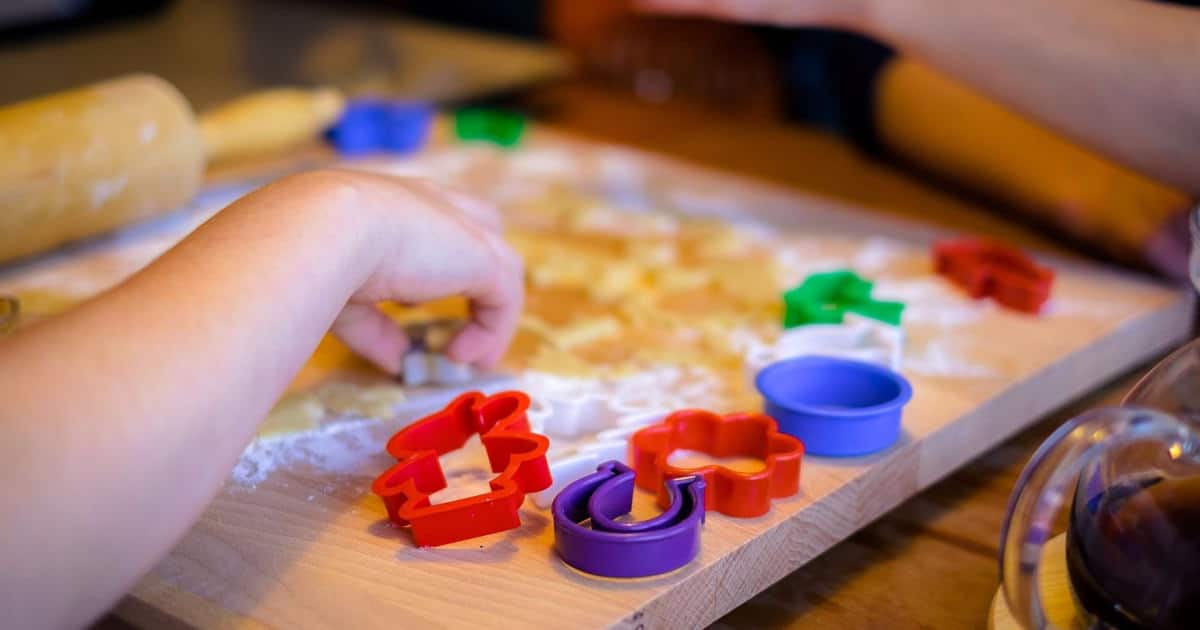 A child playing with child cookie cutters