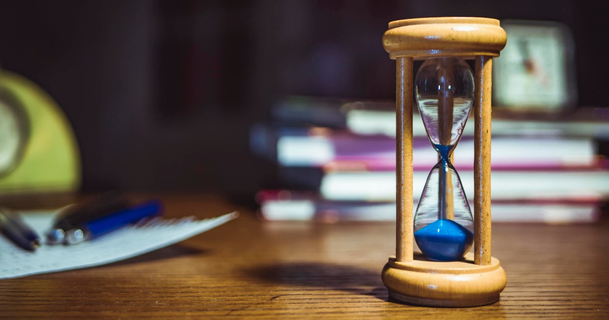 hourglass with blue sand