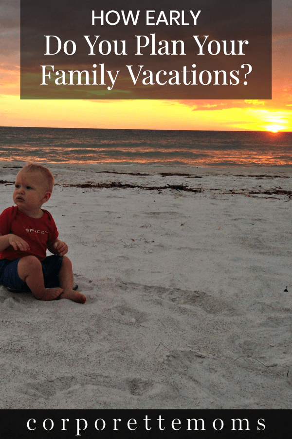 A baby sitting on the sand during sunset.