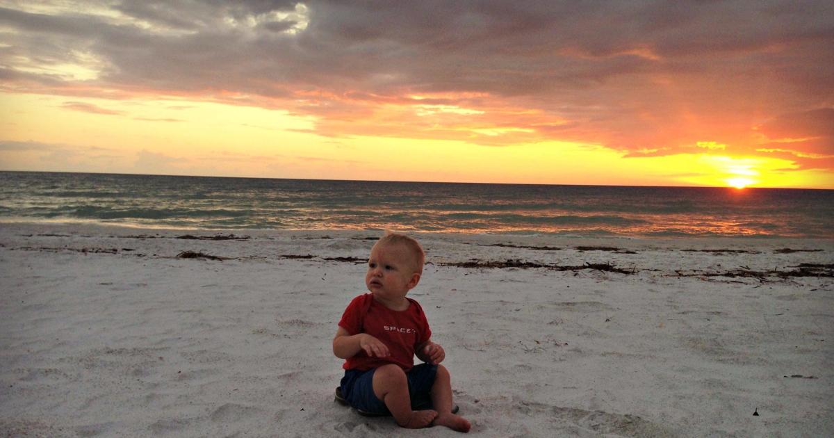 baby on beach at sunset