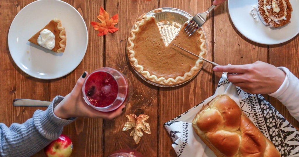 A plate of food sitting on top of a wooden table, a Thanksgiving spread