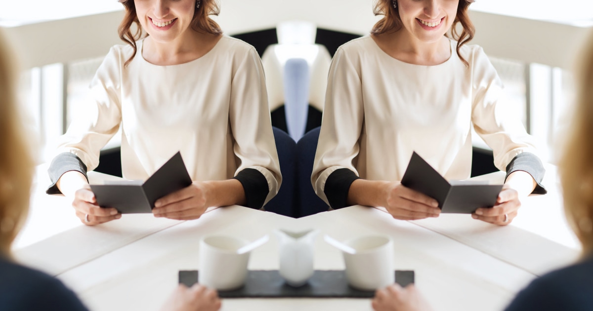 professional woman happily looking at restaurant check