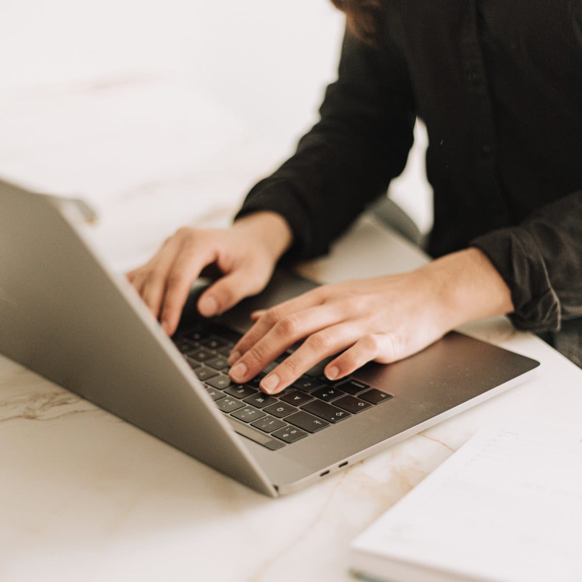 woman types on keyboard