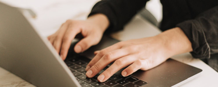 woman types on keyboard