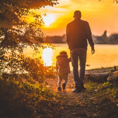 A man with his child, watching the sunset