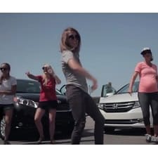 A group of women standing in front of the cars