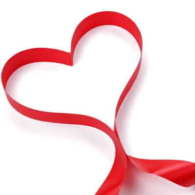 A heart-shaped red ribbon loop