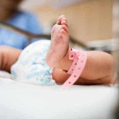 An infant's foot with a hospital bracelet