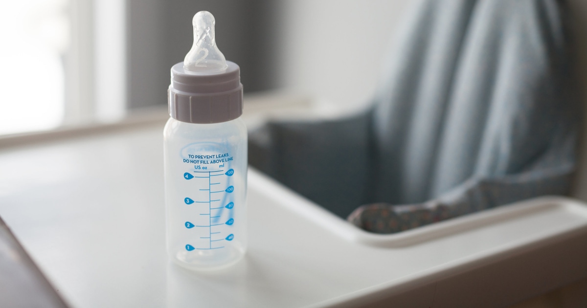 empty baby bottle on a high chair tray