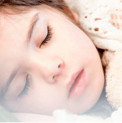 A close up of a child sleeping