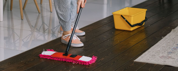 young stylish woman mopping the floor