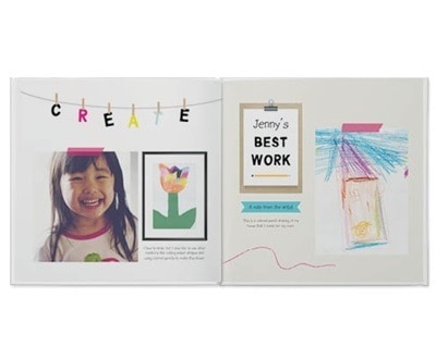 An open photo book featuring kids' art 
