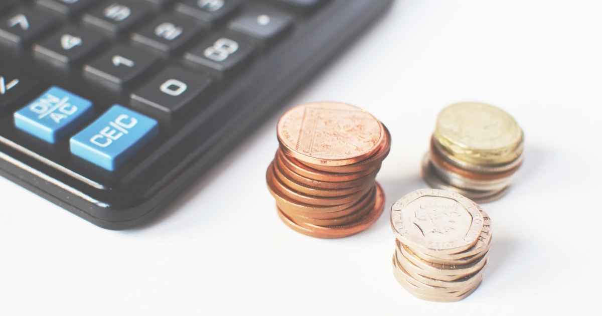 calculator and piles of coins