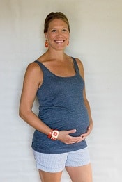 A woman wearing a sleeveless maternity top