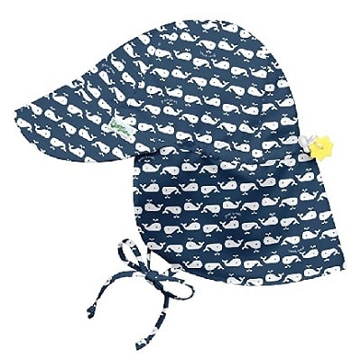 A navy sun hat for kids with a white whale print; hat has a neck flap