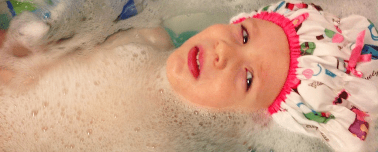 A child in the bath tub taking a bath