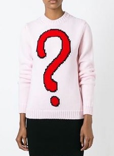 A person wearing a sweater with a question mark logo