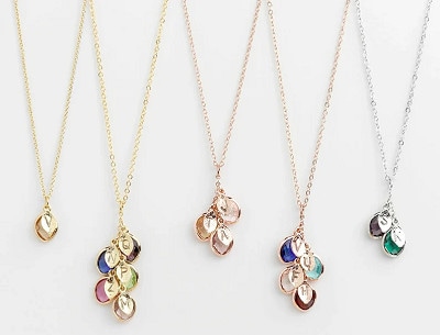 5 birthstone necklaces in different finishes with different charms and gems as pendants 
