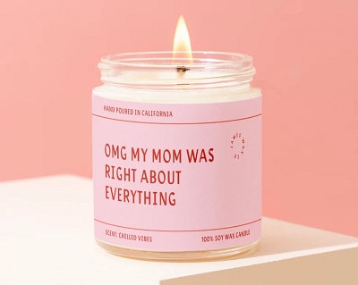 candle with pink wrapper that reads 