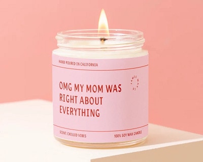 candle with pink wrapper that reads "OMG MY MOM WAS RIGHT ABOUT EVERYTHING"