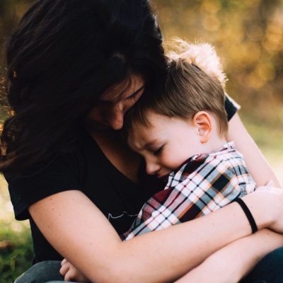 woman hugs small child, presumably her son