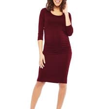 A woman wearing a 'Ellie' Ruched Maternity Dress.