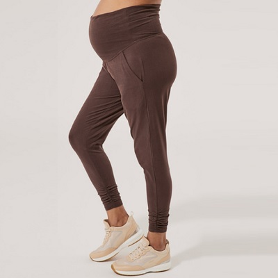 A prenant lady wearing a brown matternity jogger pants