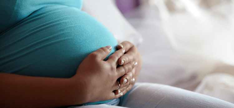 A pregnant woman sitting down 