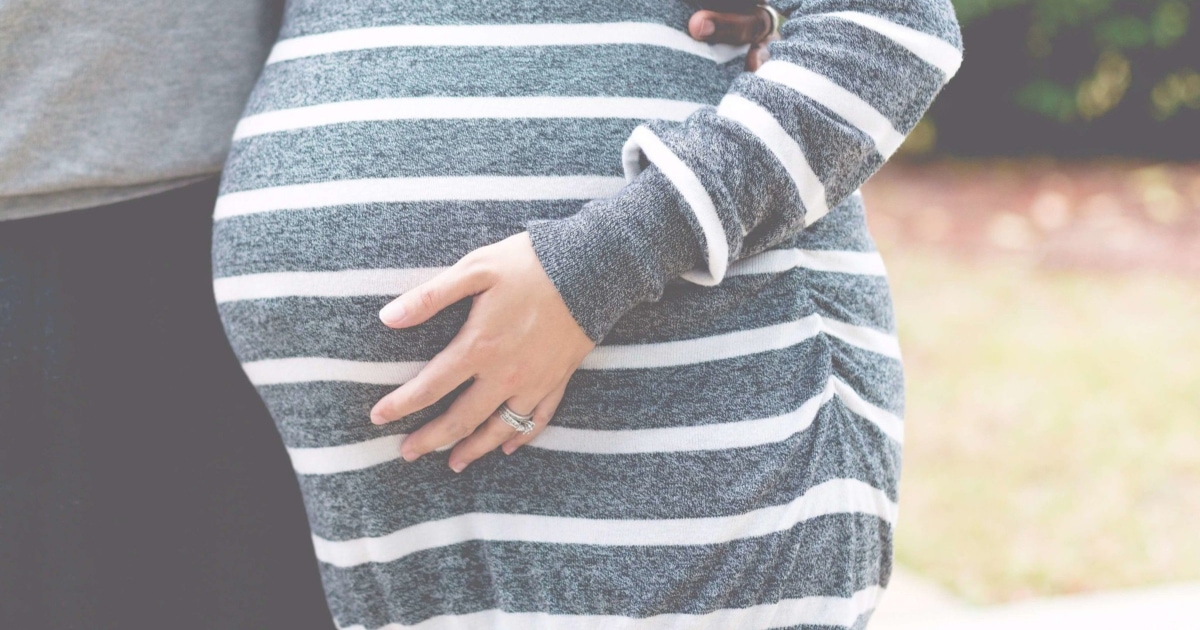 professional pregnant woman touching her belly