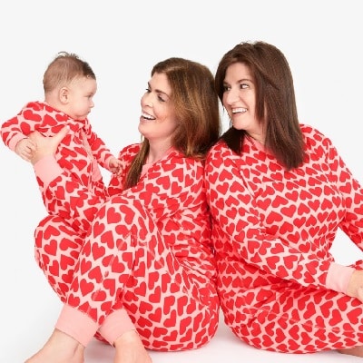 Ladies and baby wearing a red pajama set