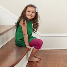 A girl sitting on the stairs.