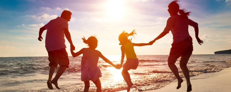 family jumping together at sunrise (concept: excited for the dawn of a new year)