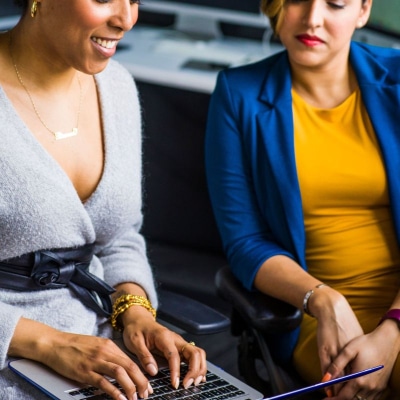 Two women in front of a laptop