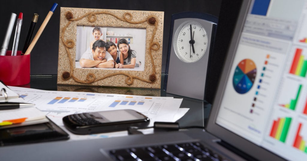 a shot of a desk that includes a family photo