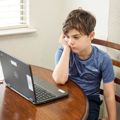A young boy using a laptop computer