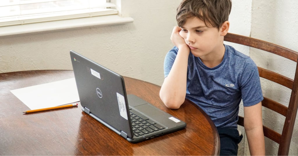 A young boy using a laptop computer