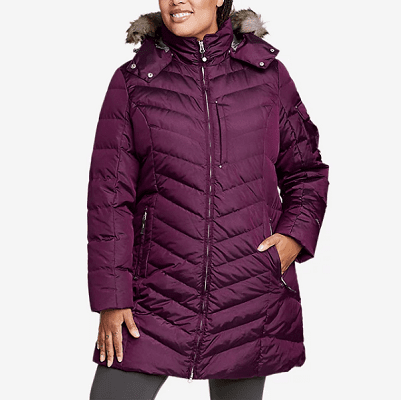 a Black woman wearing a purple puffy coat and gray pants