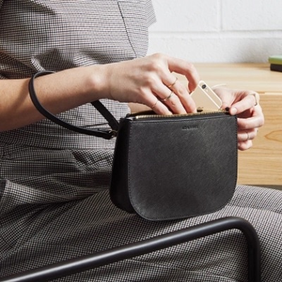 A woman holding a Waverley 2 Bag