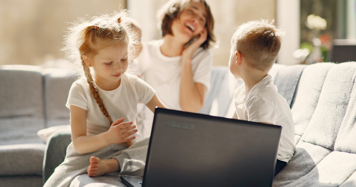 kids playing on couch with computer
