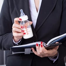 A mother holding a bottle of milk