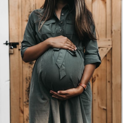 A woman wearing a maternity suit