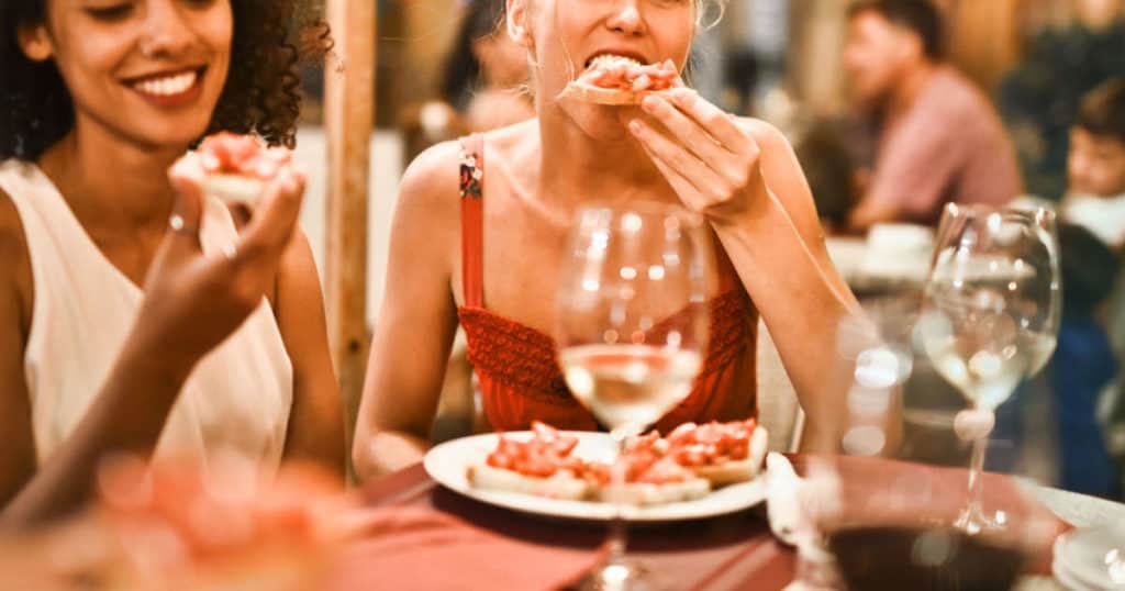 A woman sitting at a table eating food