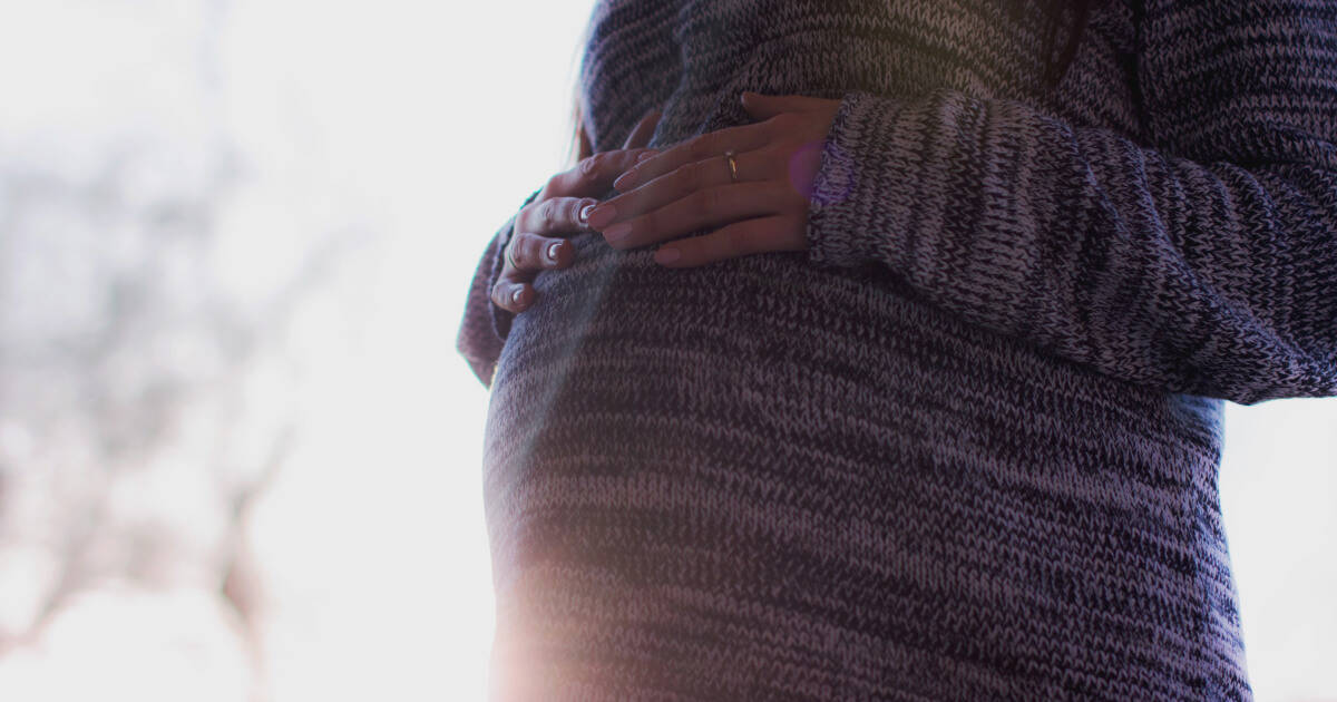 A close up of a woman's pregnant belly