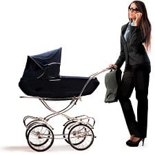 A woman holding a stroller while on her phone.