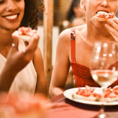 A woman sitting at a table eating food