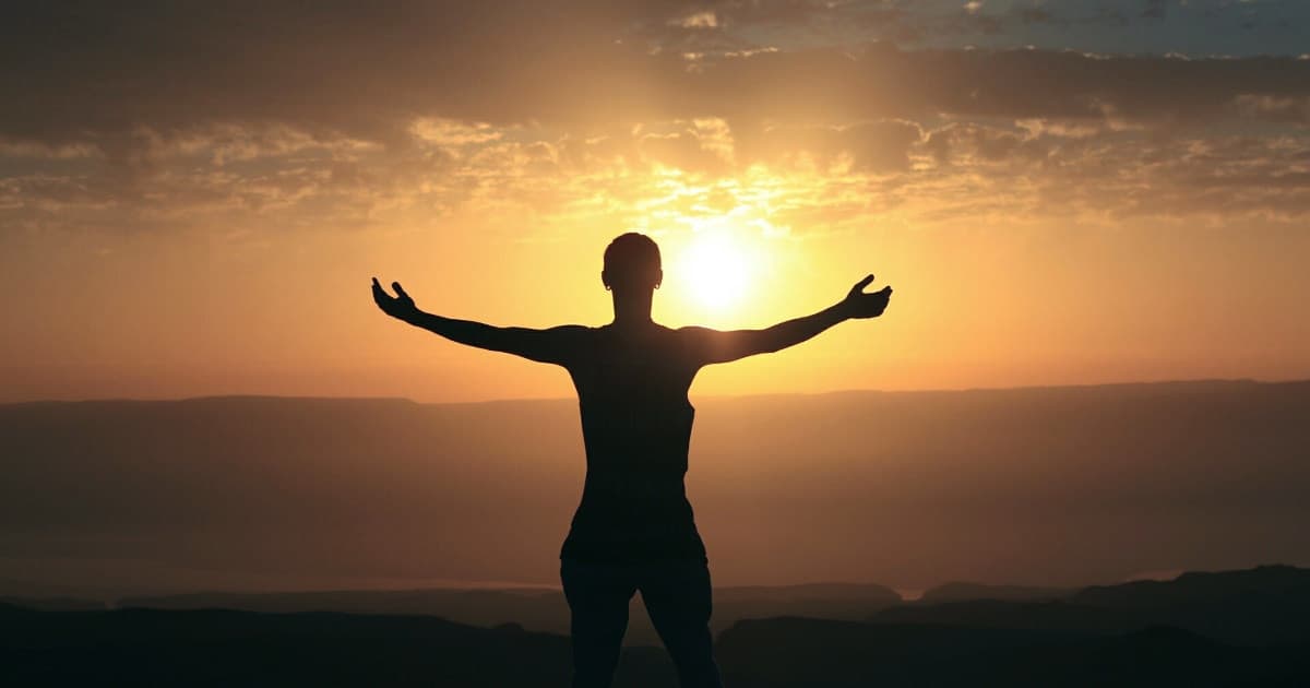 A woman\'s silhouette against the sunset